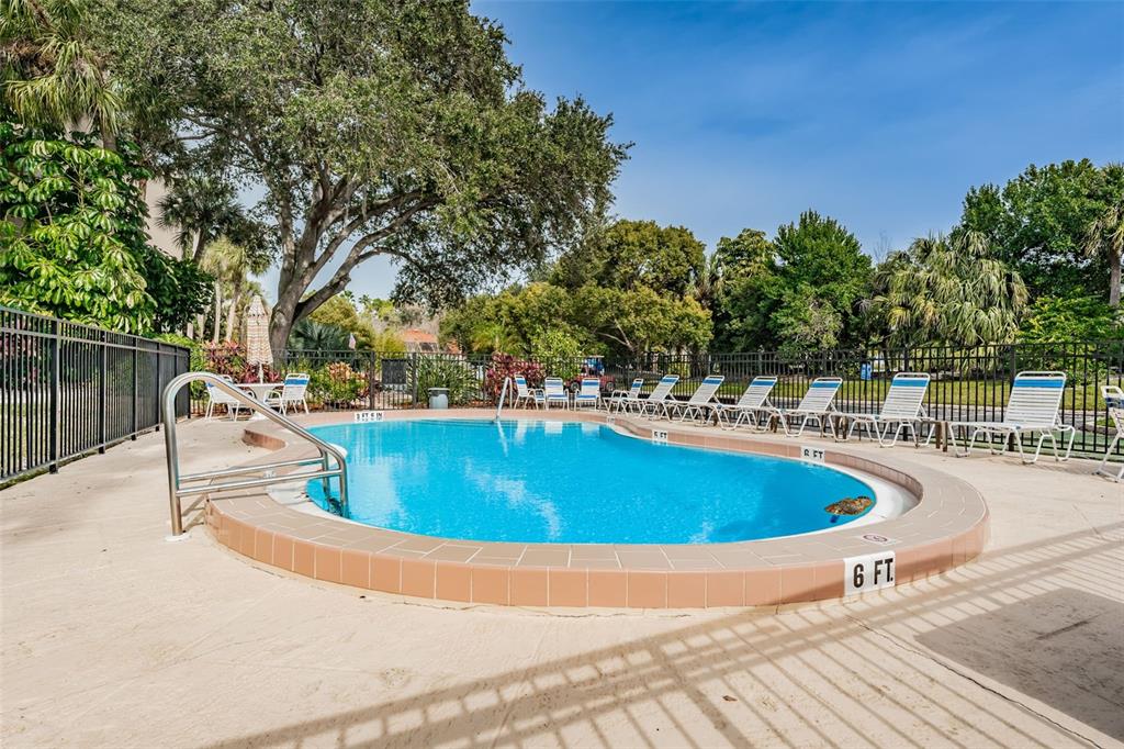 203 Tarpon Point, Unit 203 Tarpon Springs, FL 34689 - Photo 33 of 39 a view of a swimming pool with an outdoor space and seating area