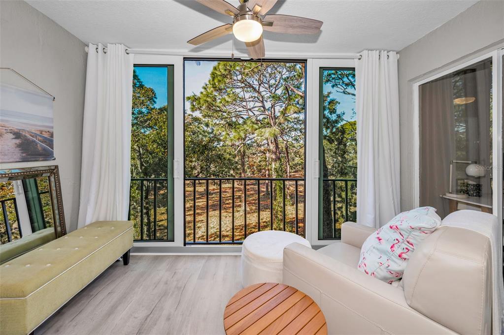 203 Tarpon Point, Unit 203 Tarpon Springs, FL 34689 - Photo 5 of 39 a bedroom with a bed and a large window with balcony view