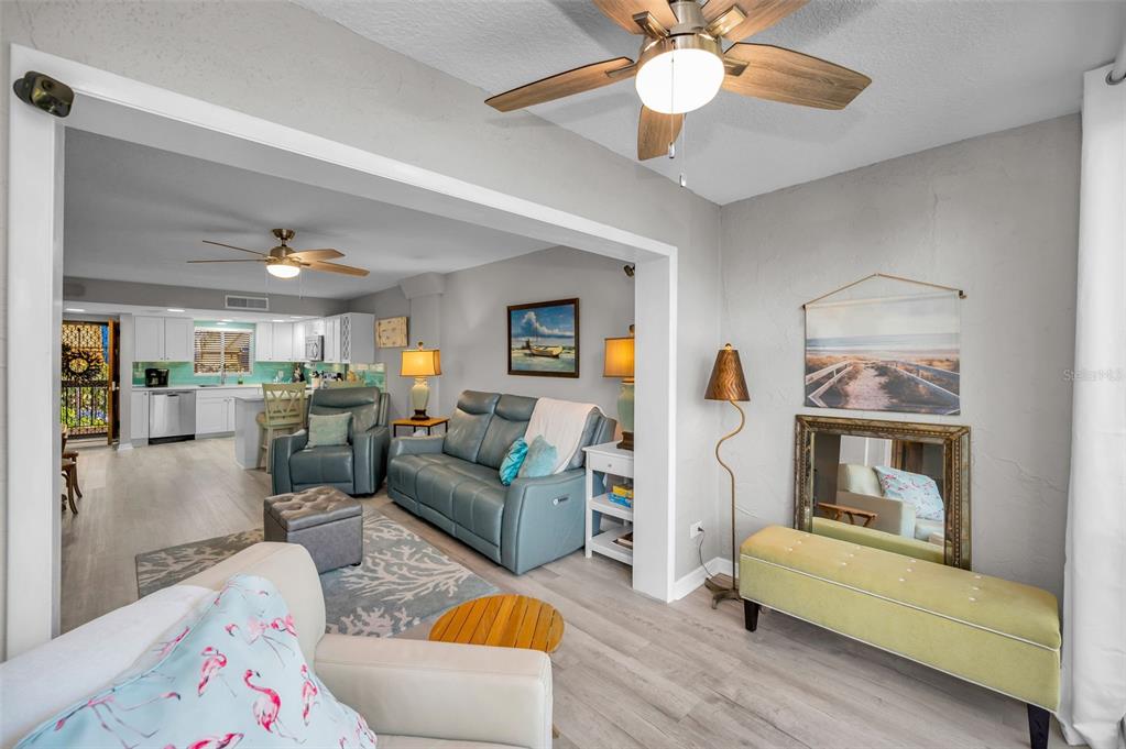 203 Tarpon Point, Unit 203 Tarpon Springs, FL 34689 - Photo 7 of 39 a living room with furniture and a wooden floor