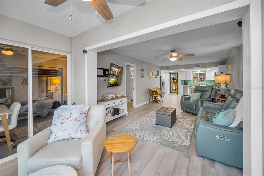 203 Tarpon Point, Unit 203 Tarpon Springs, FL 34689 - Photo 8 of 39 a living room with furniture and a flat screen tv