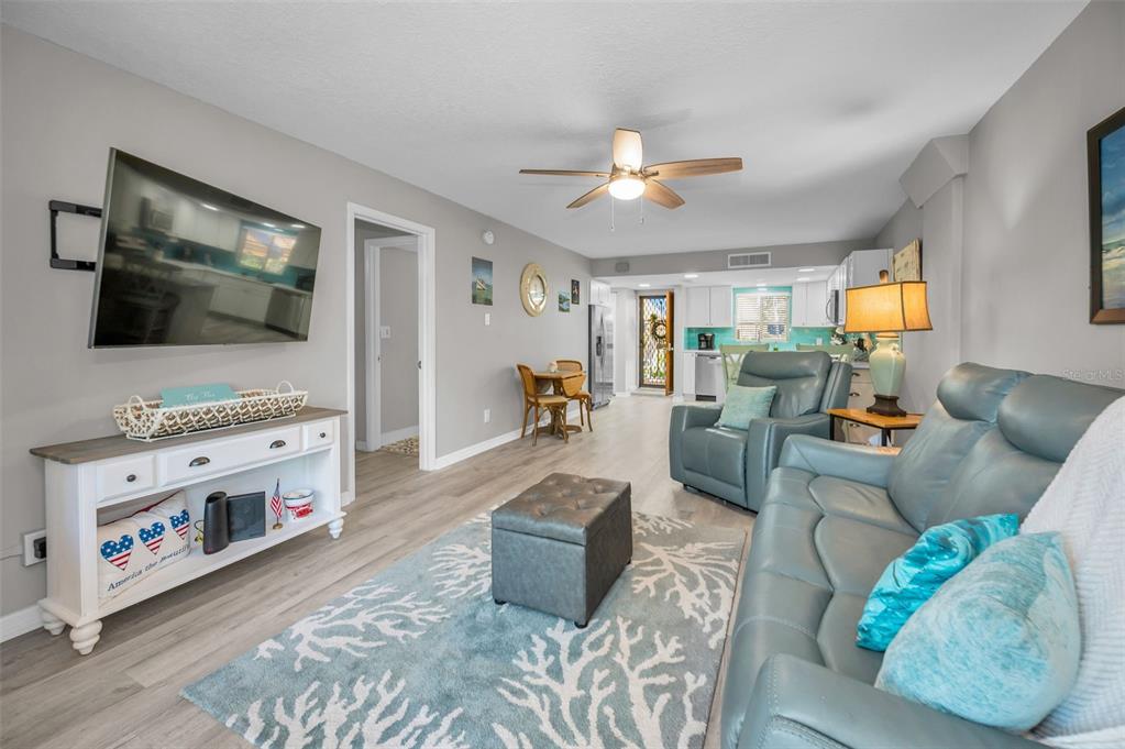 203 Tarpon Point, Unit 203 Tarpon Springs, FL 34689 - Photo 10 of 39 a living room with furniture and a flat screen tv