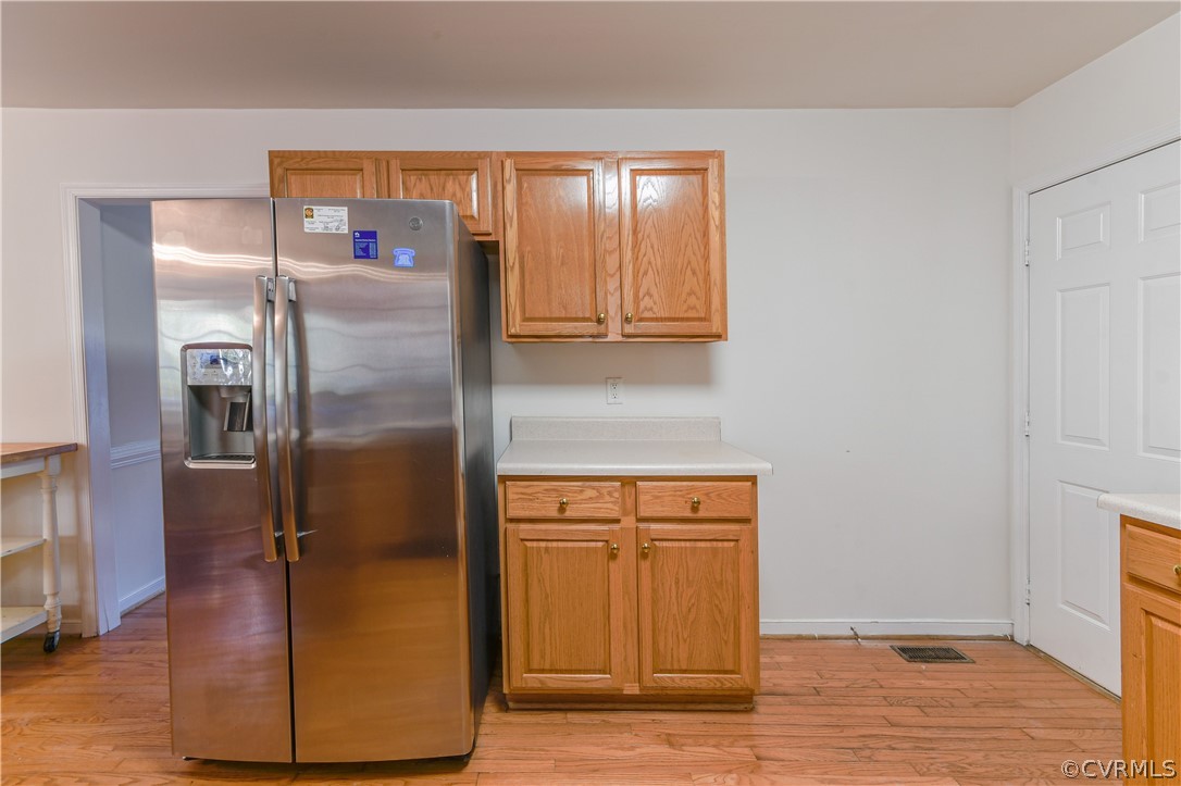 3833 Dunraven Road Chesterfield, VA 23236 - Photo 11 of 39 a view of a refrigerator in kitchen and an empty room