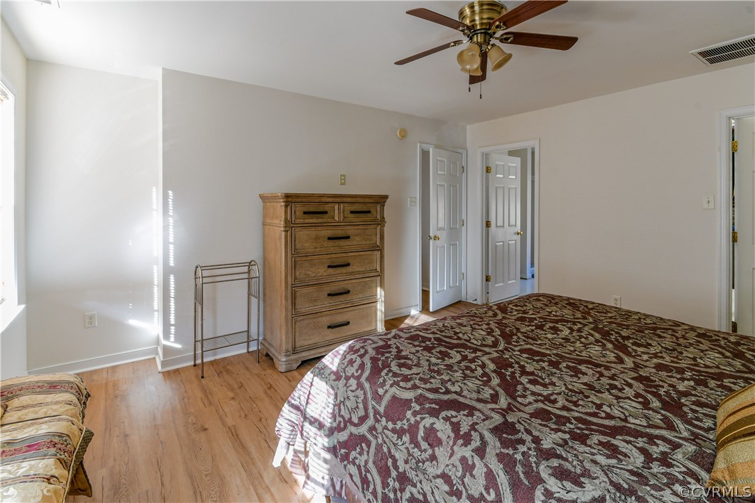 3833 Dunraven Road Chesterfield, VA 23236 - Photo 17 of 39 a bedroom with a bed and a chandelier