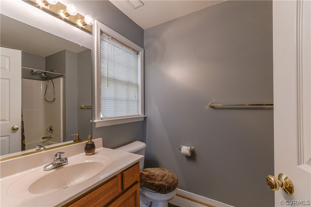 3833 Dunraven Road Chesterfield, VA 23236 - Photo 19 of 39 a bathroom with a sink vanity mirror and toilet