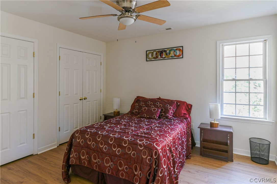 3833 Dunraven Road Chesterfield, VA 23236 - Photo 21 of 39 a bedroom with a bed and wooden floor
