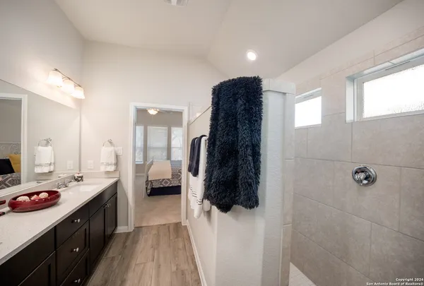 a kitchen with a refrigerator and white cabinets