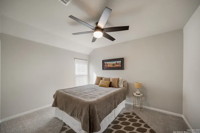 a bedroom with a bed and a painting on the wall