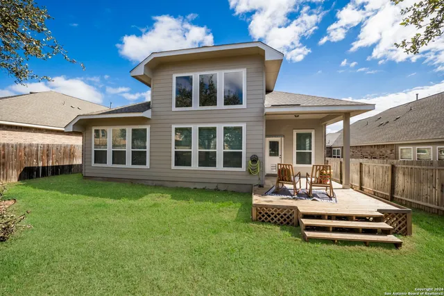a front view of a house with a yard table and chairs