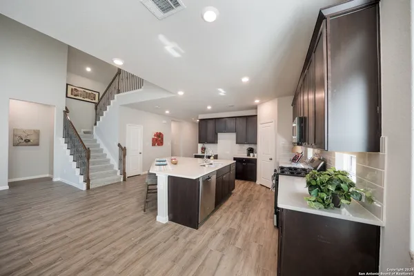a view of kitchen with cabinets and wooden floor