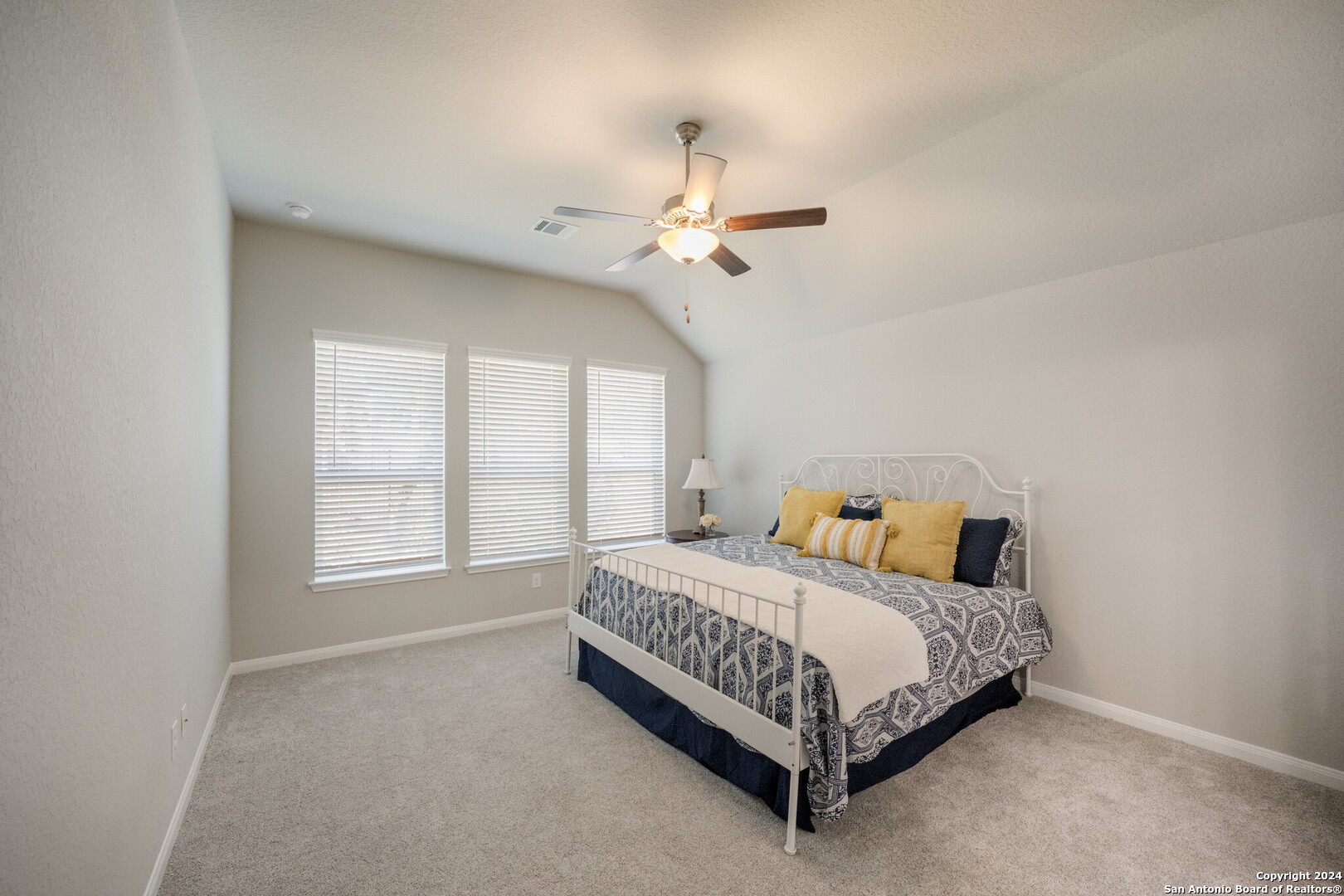 3110 Blenheim Park Bulverde, TX 78163 - Photo 9 of 20 a bedroom with a bed chandelier and a window