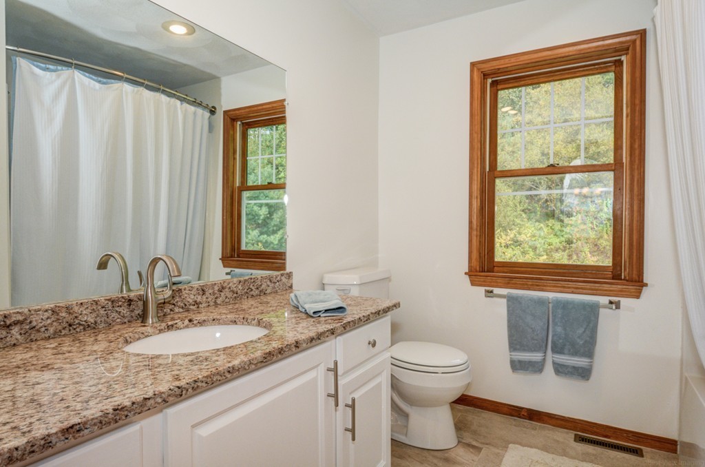 88 Providence Road Westford, MA 01886 - Photo 24 of 29 a bathroom with a granite countertop sink a toilet and a window