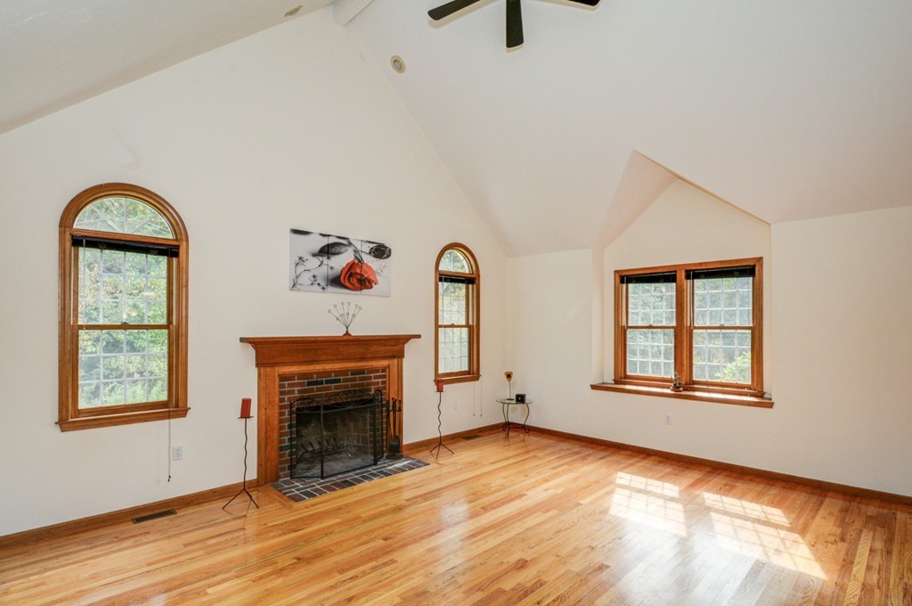 88 Providence Road Westford, MA 01886 - Photo 6 of 29 an empty room with windows fireplace and wooden floor