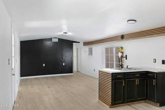a kitchen with a sink and cabinets