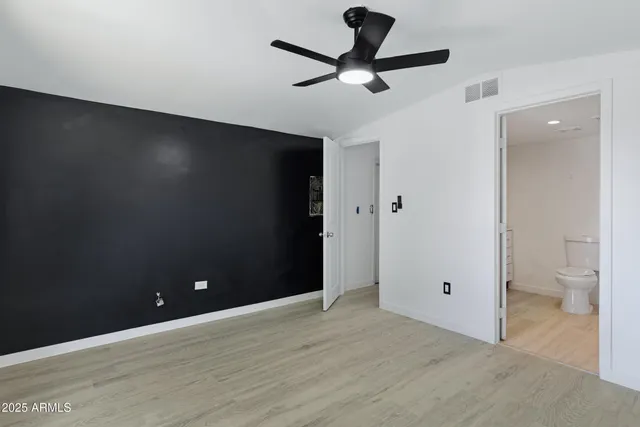 a view of an empty room and a bathroom