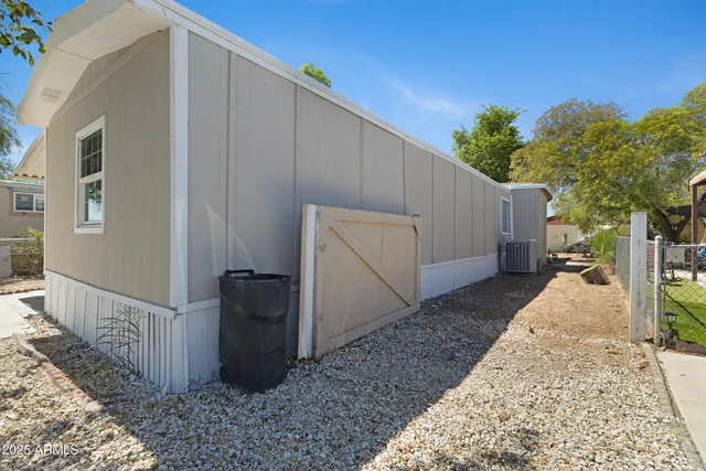 a view of a house with backyard and trees