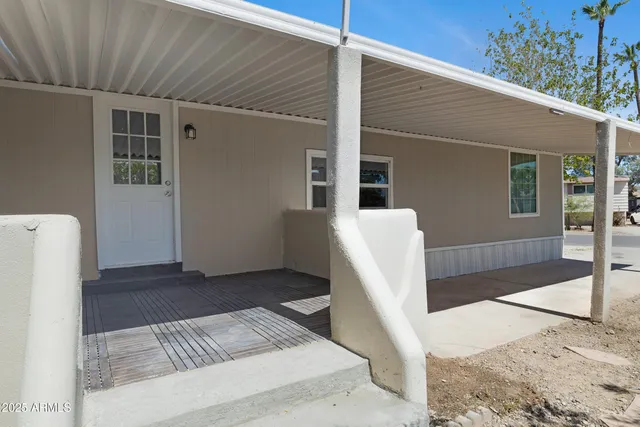 a view of a porch with furniture and floor to ceiling window