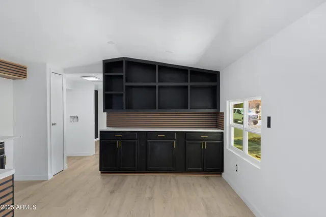 a living room with a closet and a large window