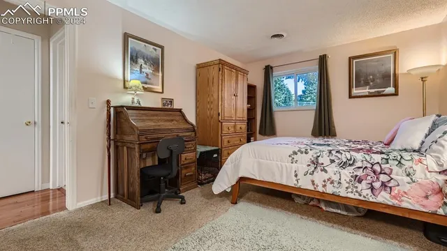 a bedroom with a bed and a view of bedroom