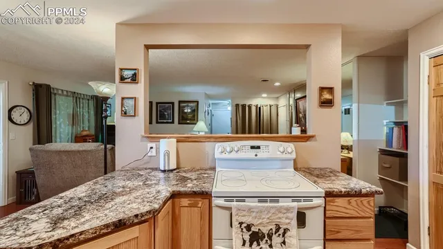 a view of living room with granite countertop furniture and fireplace