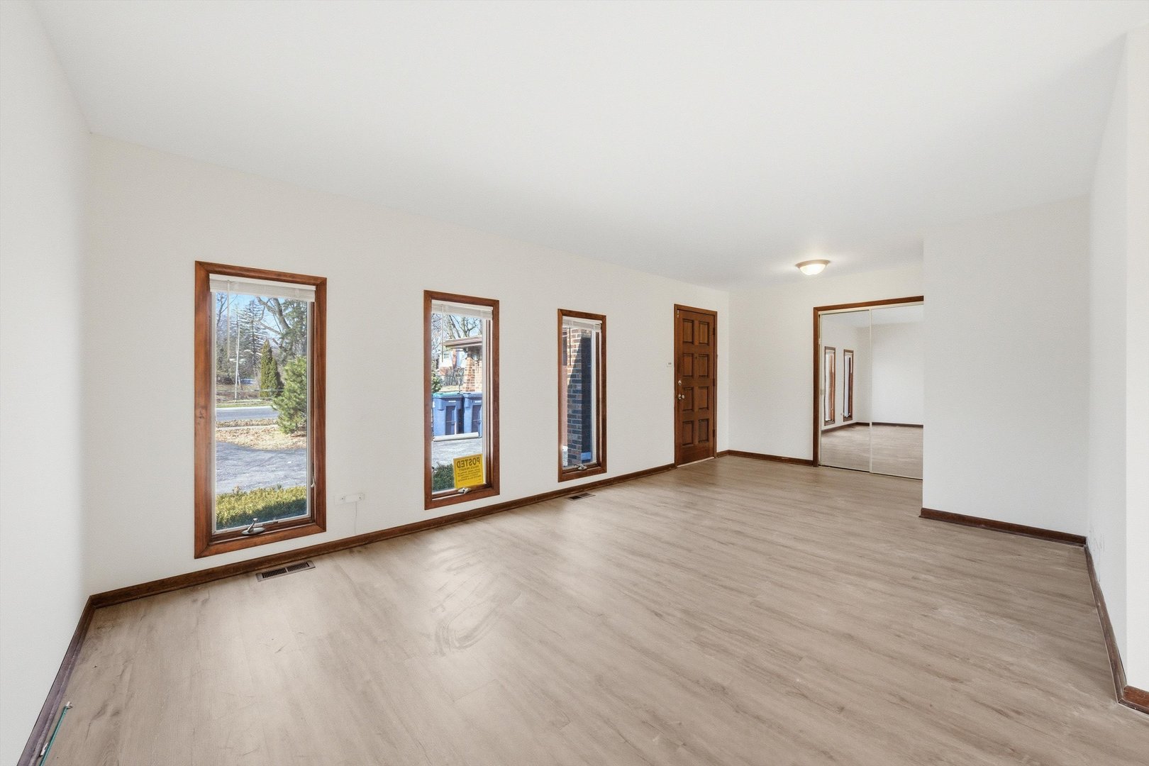 831 Violet Lane Matteson, IL 60443 - Photo 2 of 21 a view of an empty room with window and wooden floor