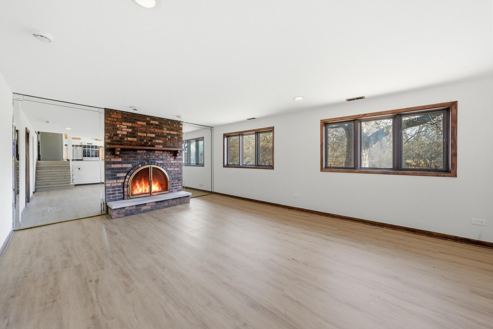 831 Violet Lane Matteson, IL 60443 - Photo 7 of 21 a view of empty room with wooden floor and fireplace