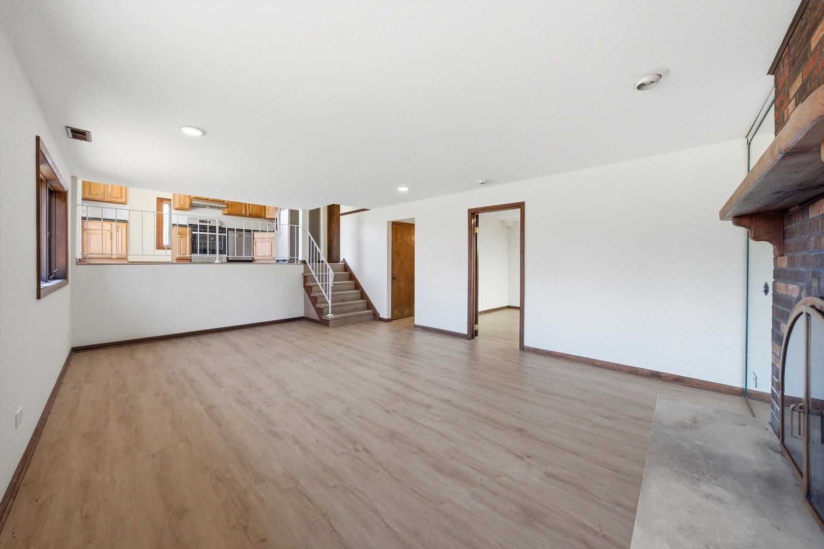 831 Violet Lane Matteson, IL 60443 - Photo 8 of 21 a view of a big room with wooden floor and windows