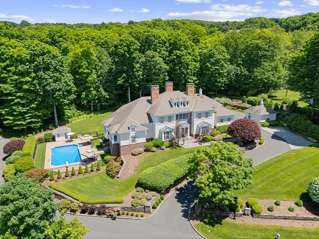 an aerial view of a house with garden space and street view