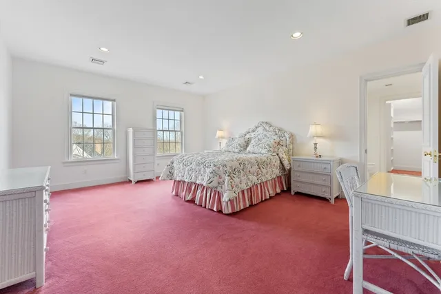 a spacious bathroom with a toilet a sink and a mirror