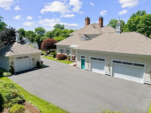 a front view of a house with a yard and a garage