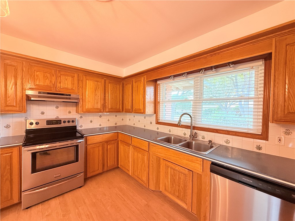 126 Marie Place Portland, TX 78374 - Photo 12 of 40 a kitchen with stainless steel appliances granite countertop a sink and a stove