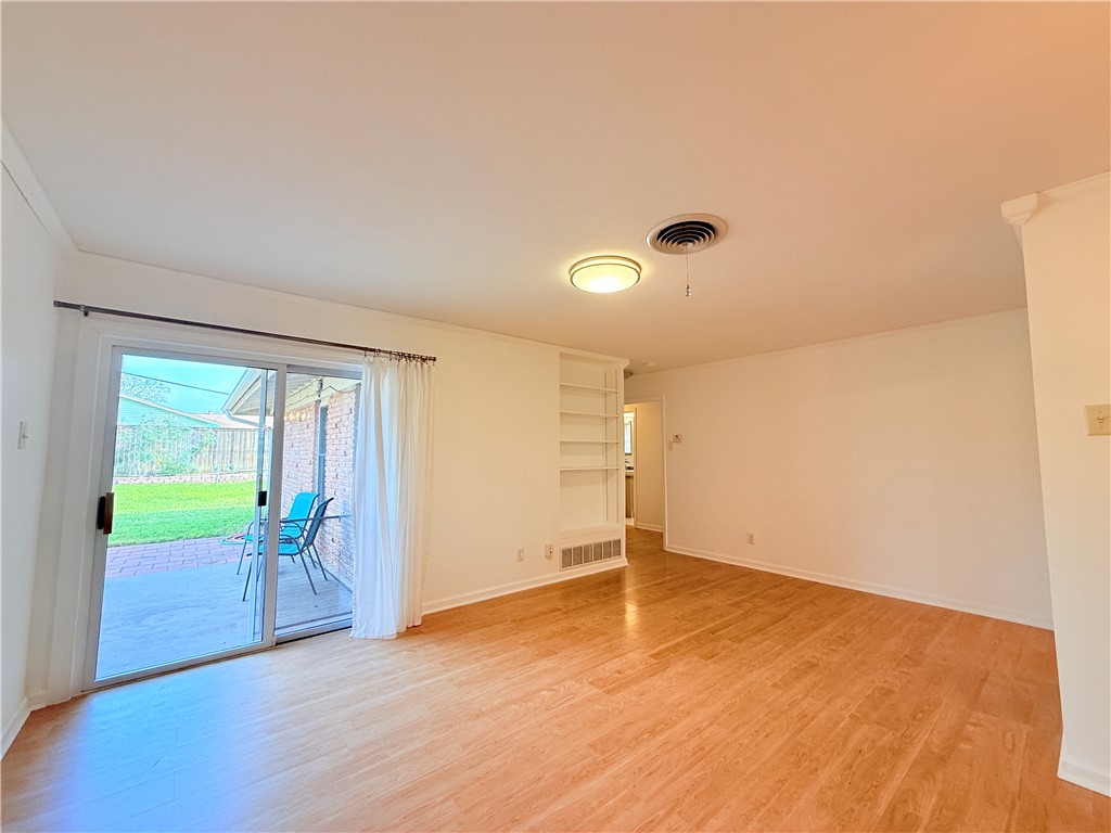 126 Marie Place Portland, TX 78374 - Photo 15 of 40 wooden floor in an empty room with a window