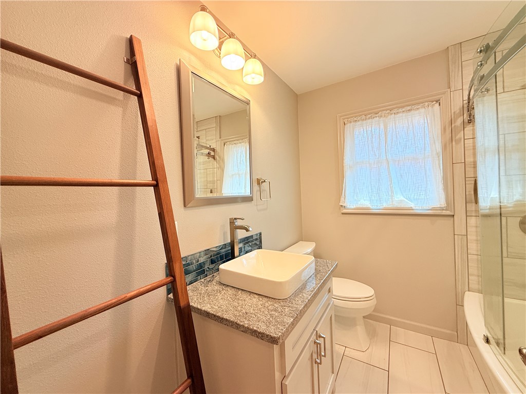 126 Marie Place Portland, TX 78374 - Photo 20 of 40 a bathroom with a granite countertop sink toilet and shower