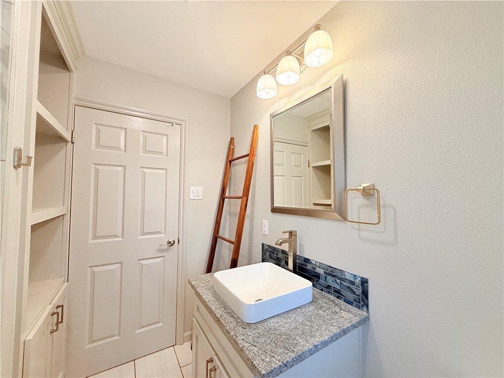 126 Marie Place Portland, TX 78374 - Photo 23 of 40 a bathroom with a granite countertop sink and a mirror