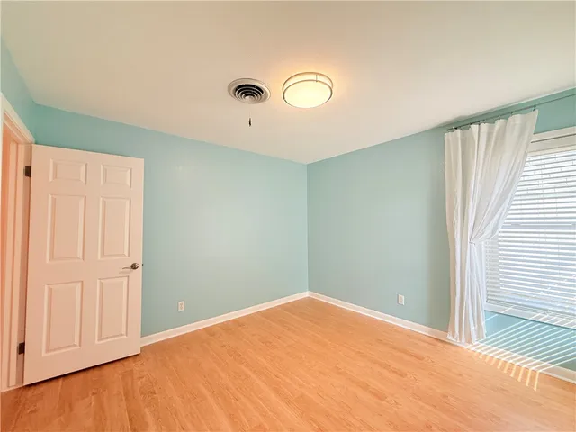 an empty room with closet and fan