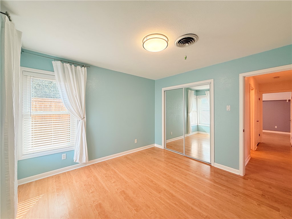 126 Marie Place Portland, TX 78374 - Photo 27 of 40 a view of an empty room with wooden floor and a window
