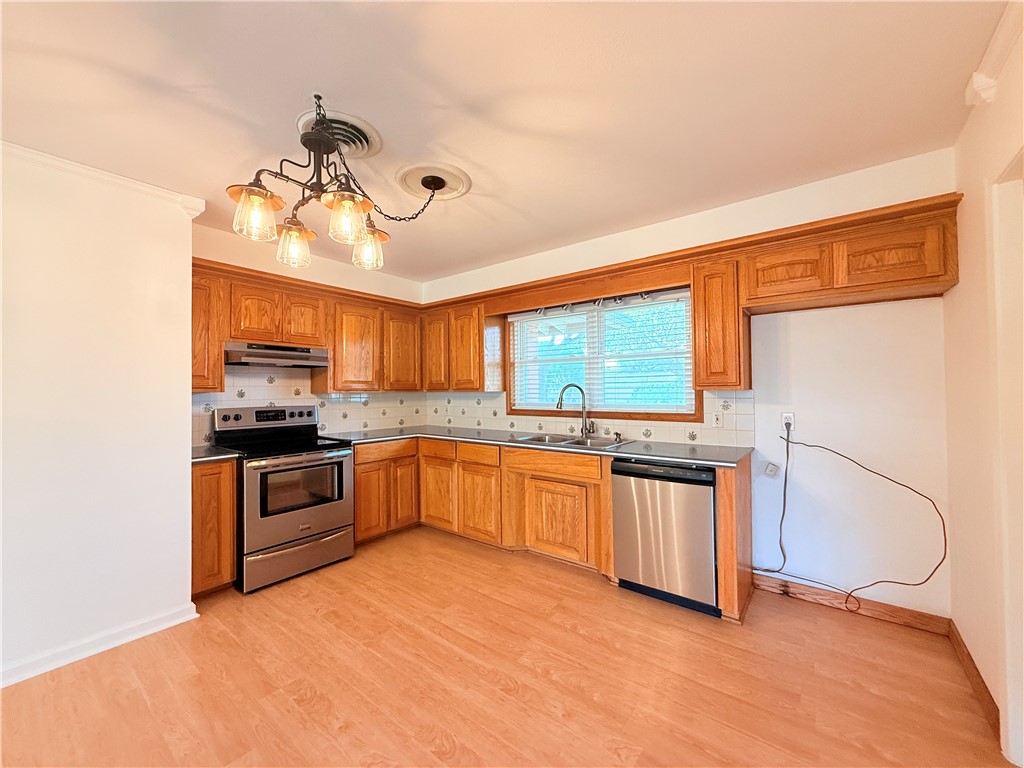 126 Marie Place Portland, TX 78374 - Photo 10 of 40 a kitchen with stainless steel appliances granite countertop a stove and a sink