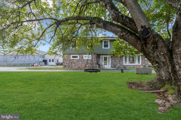 a front view of house with yard and outdoor seating