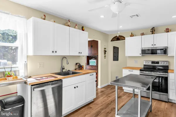 a kitchen with a table chairs refrigerator and cabinets
