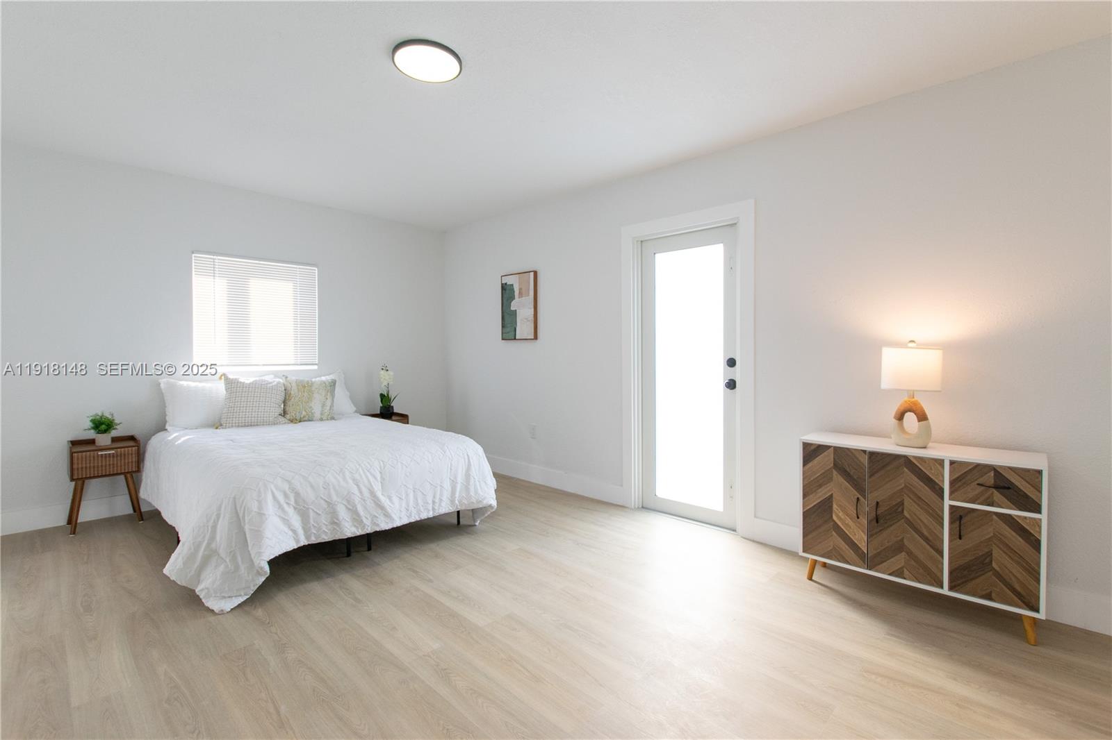 2250 Northwest 95th Terrace Miami, FL 33147 - Photo 12 of 18 a spacious bedroom with a bed and a dresser