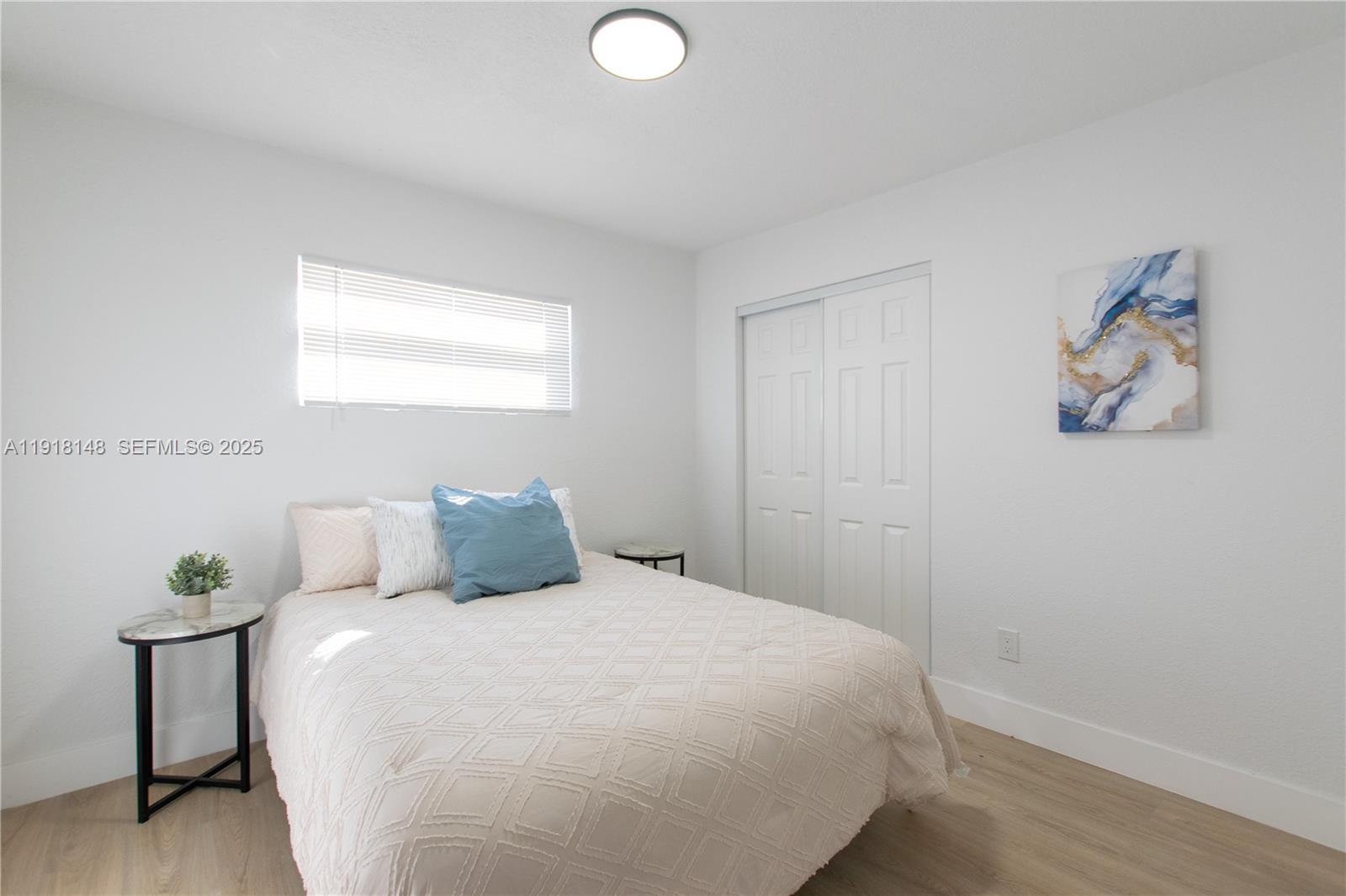 2250 Northwest 95th Terrace Miami, FL 33147 - Photo 15 of 18 a bedroom with a bed and a painting on the wall