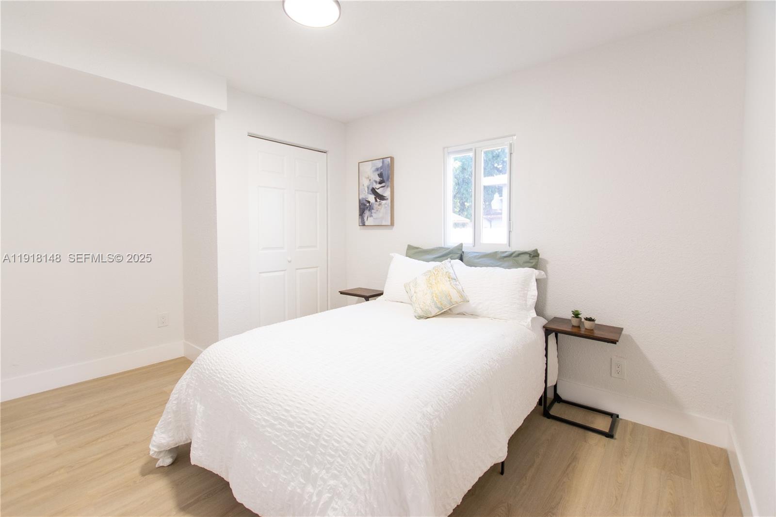 2250 Northwest 95th Terrace Miami, FL 33147 - Photo 16 of 18 a bedroom with a bed and painting on the wall