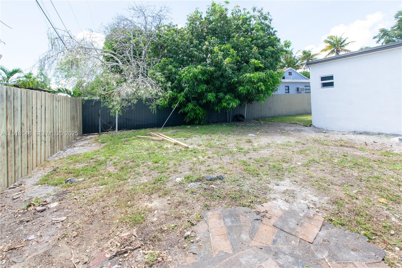 2250 Northwest 95th Terrace Miami, FL 33147 - Photo 17 of 18 a backyard of a house with plants and trees