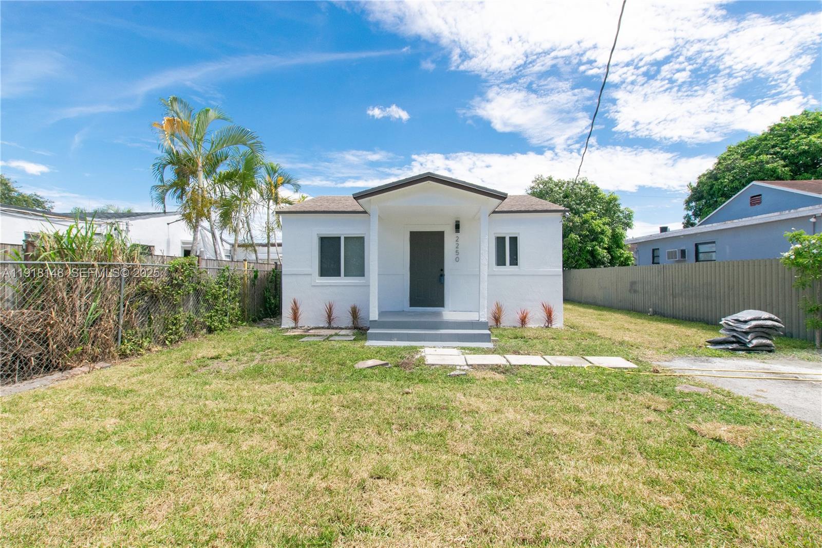 2250 Northwest 95th Terrace Miami, FL 33147 - Photo 4 of 18 a view of a house with a yard and potted plants