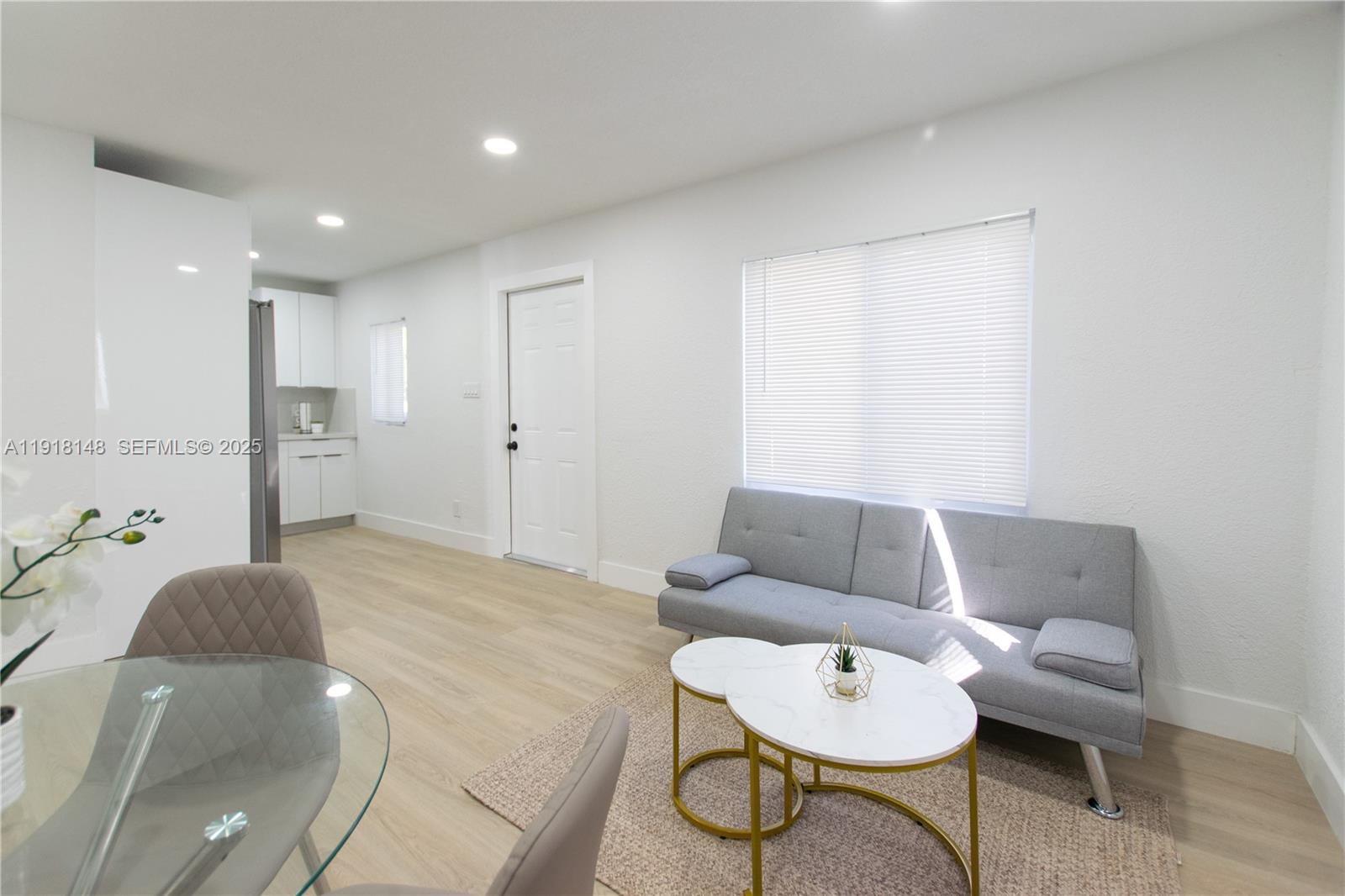 2250 Northwest 95th Terrace Miami, FL 33147 - Photo 6 of 18 a living room with furniture and a wooden floor