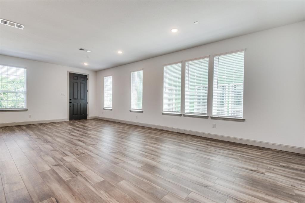 8913 Swallowtail Street Frisco, TX 75035 - Photo 4 of 38 an empty room with wooden floor and windows