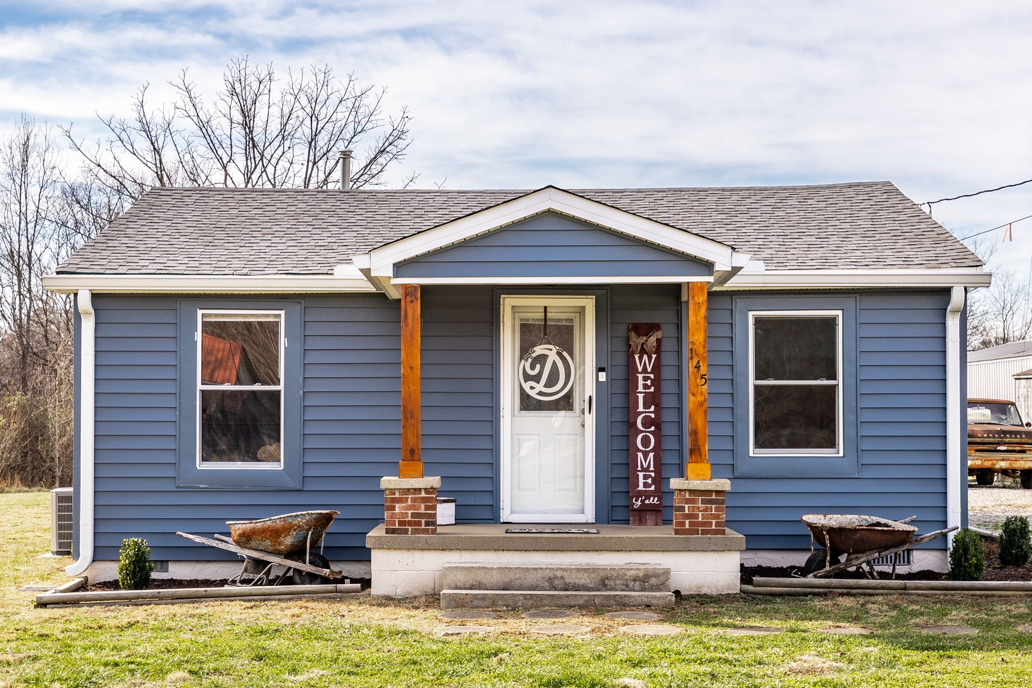 145 New Deal Potts Road Cottontown, TN 37048 - Photo 1 of 40 a front view of a house with swimming pool and furniture