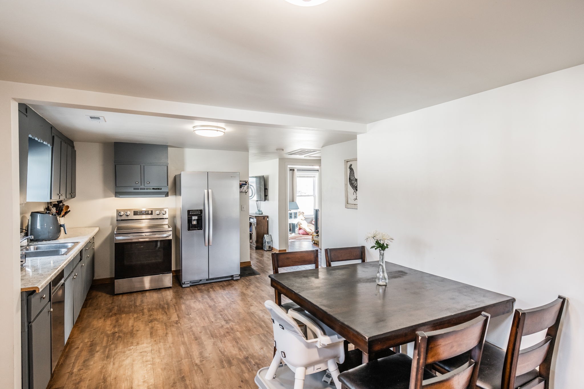 145 New Deal Potts Road Cottontown, TN 37048 - Photo 18 of 40 a kitchen with stainless steel appliances granite countertop a stove a refrigerator a sink a dining table and chairs
