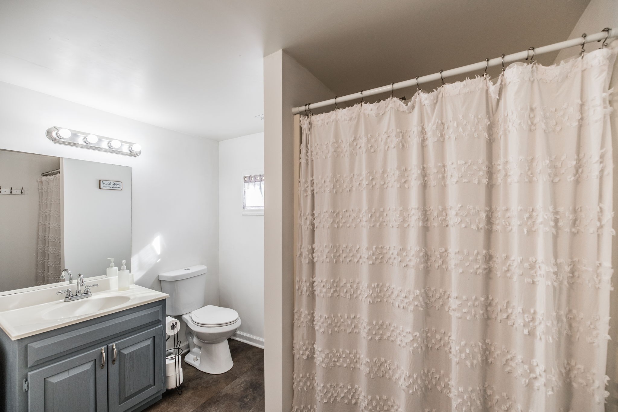 145 New Deal Potts Road Cottontown, TN 37048 - Photo 26 of 40 a bathroom with a toilet a sink and a shower curtain