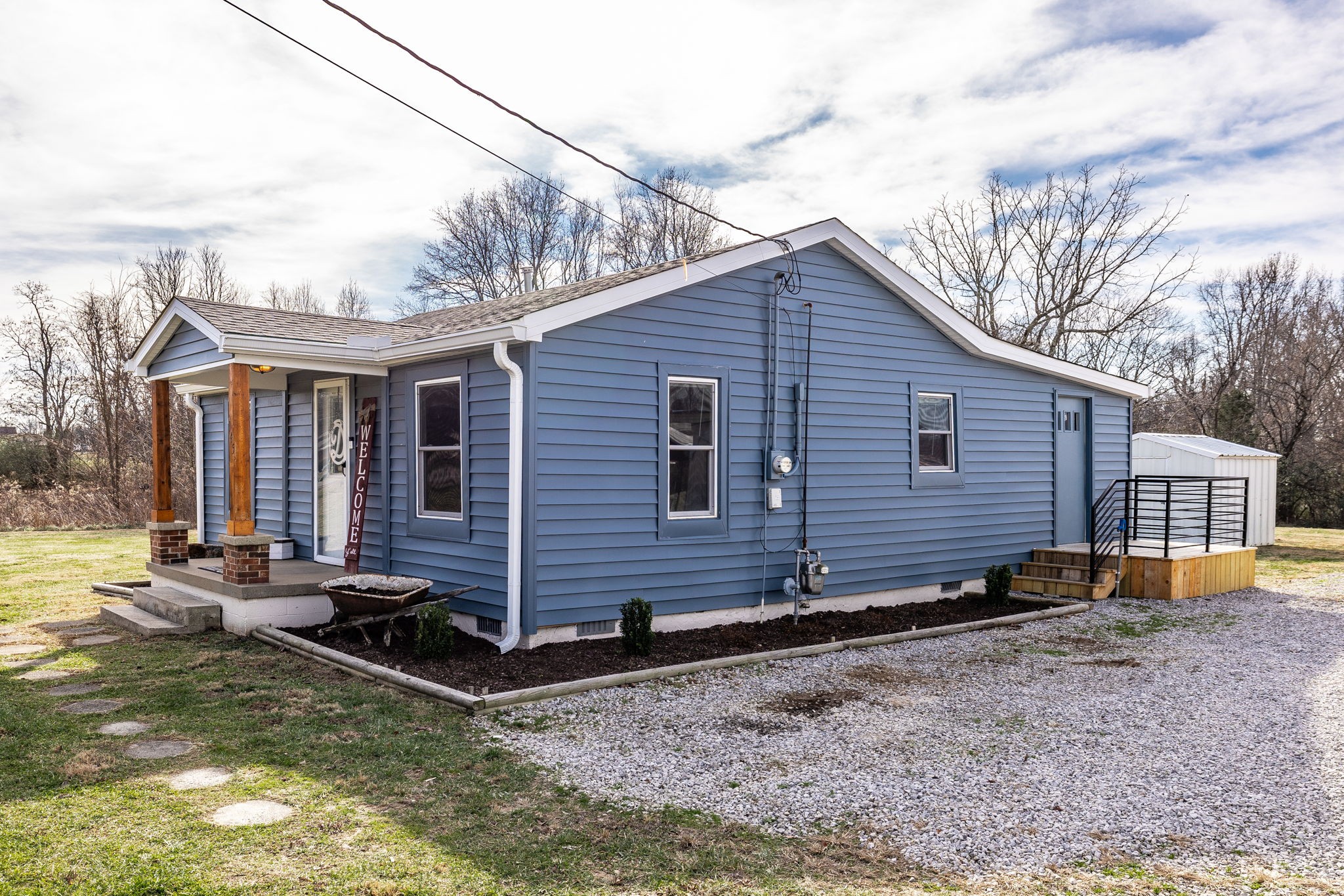 145 New Deal Potts Road Cottontown, TN 37048 - Photo 32 of 40 a view of a house with a yard and lawn chairs