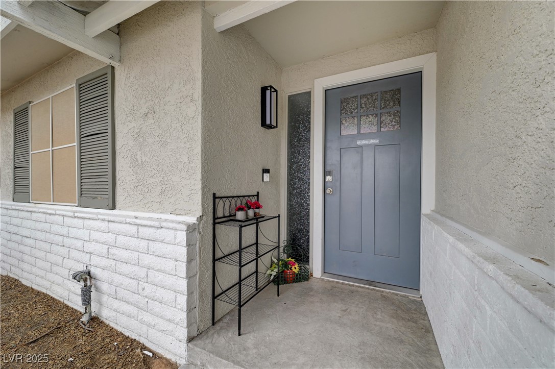 2829 Michael Way Las Vegas, NV 89108 - Photo 14 of 60 Property entrance with stucco siding and brick siding